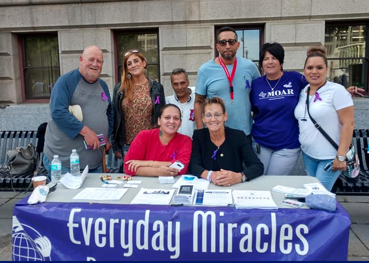 Everyday Miracles Group around a table